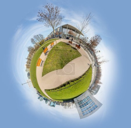 scenic panorama of Spreebogen park in Berlin with government buildings in Berlin in early morning light in tiny planet format