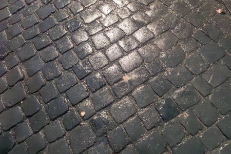 Photo for Pattern of  wet cobble stone with sparse light - Royalty Free Image