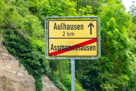yellow entrance sign to village of Aulhausen in 2 kilometer and city limit of Assmannshausen