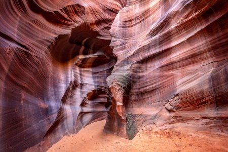 Cardiac slot canyon near Page Arizona highlights the narrow passageway and amazing, glowing light and intricate patterns that form over millions of years from the combination of water and sediment flow.