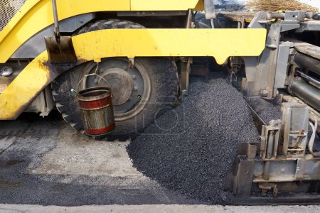 Foto de Finalizador de pavimentadora, finalizador de asfalto o máquina de pavimentación colocando una capa de asfalto. Repavimentación - Imagen libre de derechos