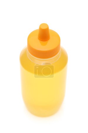 Foto de Botella de plástico de miel sobre fondo blanco - Imagen libre de derechos