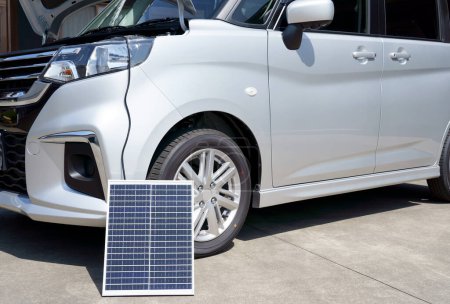 Photo for Portable solar panel charges the car battery. - Royalty Free Image