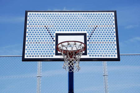 Photo for Photos of basketball hoop on empty outdoor court on a blue sky. - Royalty Free Image