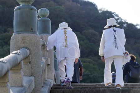 Photo for Zentsuji, Kagawa, Japan - November 23th 2023: Ohenro pilgrims on the grounds of Zentsuji-Temple, temple number 75 of Shikoku pilgrimage - Royalty Free Image