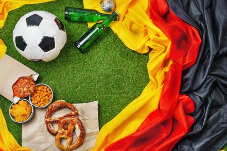 Photo for German soccer ball and flag with green grass copy space. - Royalty Free Image