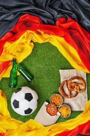 Photo for German soccer ball and flag with green grass copy space. - Royalty Free Image