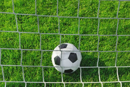 Photo for Textured soccer game field with close-up ball in front of the soccer goal - soccer ball in soccer net. - Royalty Free Image