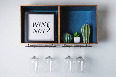 Frame with humorous text lettering Wine Not. wine glass holder rack with a playful sign, succulent plant, and decorative design for wine holder