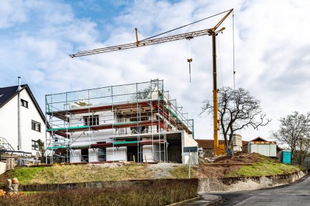 Photo for Construction of new houses n the settlement. A building under construction and a construction crane on the sky background - Royalty Free Image