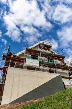 Photo for Construction of new houses in the village. A building under construction and scaffolding against the sky - Royalty Free Image