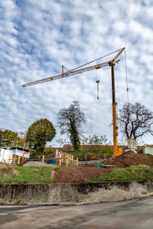 Photo for Construction of new houses in the settlement. A building under construction and a construction crane on the sky background - Royalty Free Image
