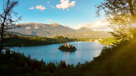 Téléchargez les photos : Images aériennes 4K de vol autour de l'église de pèlerinage de l'Assomption de Maria au-dessus du lac de Bled par une belle journée d'automne avec des nuages. Lac de Bled, Slovénie. - en image libre de droit