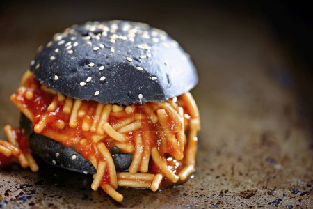 Photo for Closeup of charcoal bun spaghetti sandwich - Royalty Free Image