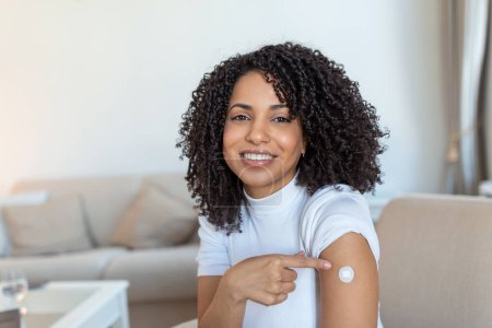 Photo for Covid-19 Vaccination. Portrait Of Happy Vaccinated African woman Showing Her Arm After Coronavirus Antiviral Vaccine Shot . Covid Immunization Campaign Concept. - Royalty Free Image