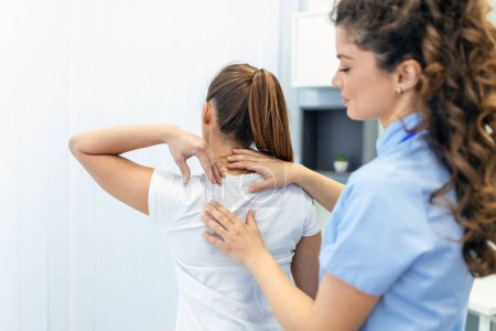 Photo for Physiotherapist doing healing treatment on womans back. Back pain patient, treatment, medical doctor, massage therapist.office syndrome - Royalty Free Image