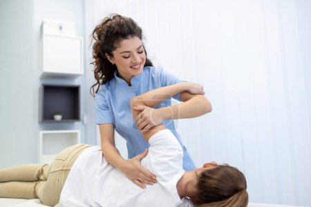 Photo for Physiotherapist treatment patient. Holding patient's hand, shoulder joint treatment. Physical Doctor consulting with patient About Shoulder muscule pain problems Physical therapy diagnosing concept - Royalty Free Image