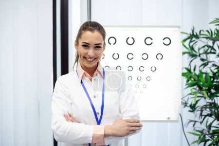 Photo for Close-up of female ophthalmologist testing patient with letters on special board. Copy space in left side. Professional attractive eye doctor in office at hospital. Modern medicine concept - Royalty Free Image
