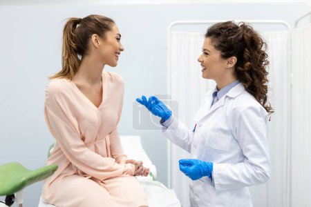 Photo for Gynecologist talking with young female patient during medical consultation in modern clinic. Patient with a gynecologist during the consultation in the gynecological office - Royalty Free Image