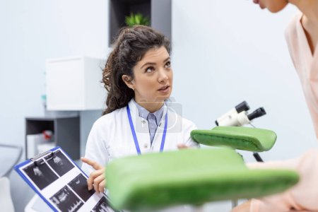 Photo for Patient woman getting a consultation on the results of the analyzes from her gynecologist. Gynecology and treatment of gynecological diseases - Royalty Free Image
