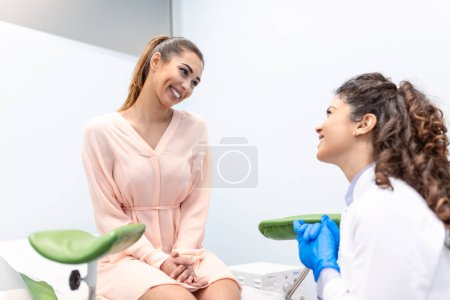 Photo for Happy woman visit gynecologist doctor at hospital or medical clinic for pregnancy consultant. Doctor examine belly for baby and mother healthcare check up. Gynecology concept. - Royalty Free Image
