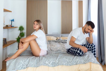 Photo for Relationship concept. Top view of young couple lying on the bed. Couple having a fight in the bed. concept about relationship and problems between couples. Sexual frustration. Lovers ignore each other - Royalty Free Image