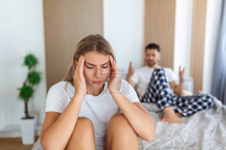 Foto de Couple quarreling due to jealousy in relationship at home, young couple with relationship problem appear depressed and frustrated. - Imagen libre de derechos