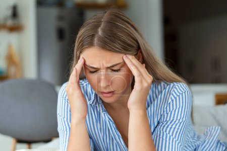 Photo for Sinus ache causing very paintful headache. Unhealthy woman in pain. Sharp strong sore. Sinus pain, sinus pressure, sinusitis. Sad woman holding her head because sinus pain - Royalty Free Image
