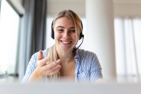 Photo for Young friendly operator woman agent with headsets. Beautiful business woman wearing microphone headset working in the office as a telemarketing customer service agent, call center job concept. - Royalty Free Image