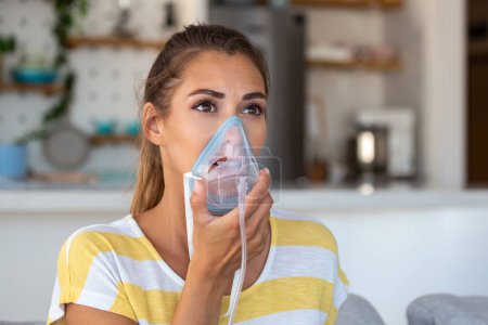 Photo for Sick woman making inhalation, medicine is the best medicine. Ill woman wearing an oxygen mask and undergoing treatment for covid-19. woman with an inhaler - Royalty Free Image