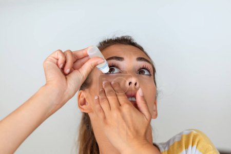 Photo for Woman using eye drop, woman dropping eye lubricant to treat dry eye or allergy, sick woman treating eyeball irritation or inflammation woman suffering from irritated eye, optical symptoms - Royalty Free Image