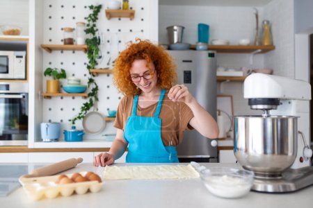 Photo for Baking Concept. Portrait Of Joyful Woman Kneading Dough In Kitchen Interior, Cheerful Female In Apron Having Fun While Preparing Homemade Pastry, - Royalty Free Image