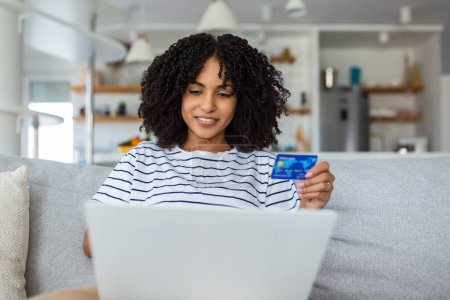 Photo for Pretty woman shopping online with credit card. woman holding credit card and using laptop. Online shopping concept - Royalty Free Image