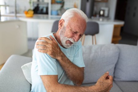 Photo for Senior elderly man touching his shoulder, suffering from shoulder pain, sciatica, sedentary lifestyle concept. shoulder health problems. Healthcare, insurance - Royalty Free Image