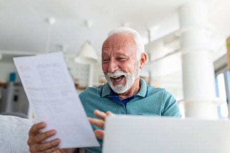 Photo for Surprised laughing happy old mature retired man looking through paper document, feeling excited analyzing financial information, getting taxes refund or bank loan approval at home. - Royalty Free Image