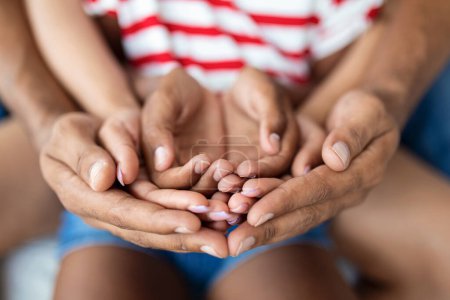 Photo for Parents and child placing their hands together, closeup shot - Royalty Free Image