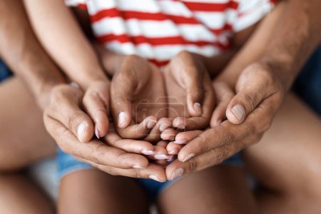 Téléchargez les photos : Les parents et l'enfant mettent leurs mains ensemble, gros plan - en image libre de droit