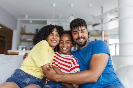 Photo for Loving diverse parents spend time with little adorable daughter have fun together at modern home smiling laughing, close up. Happy multi-ethnic family concept - Royalty Free Image