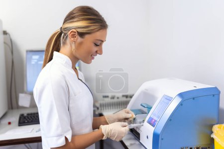 Photo for Blood hematology analyzer. Close up of medical worker in lab. - Royalty Free Image
