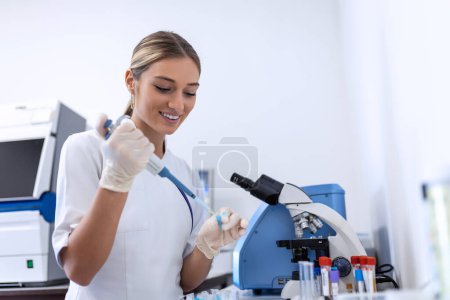 Photo for Modern Medical Research Laboratory: Female Scientist Working with Micro Pipette, Analysing Biochemicals Samples. Advanced Scientific Lab for Medicine, Microbiology Development. - Royalty Free Image