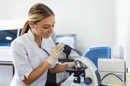 Photo for Scientist biochemist or microbiologist working research with a microscope in laboratory. - Royalty Free Image