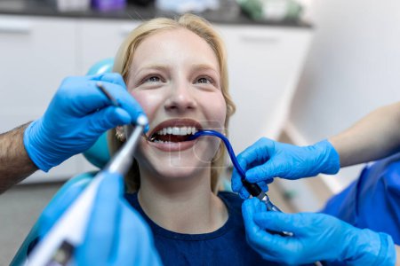 Foto de Teeth health concept. Cropped photo of smiling woman mouth under treatment at dental clinic, panorama - Imagen libre de derechos