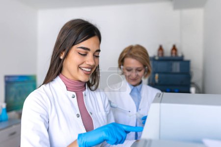 Photo for Two Research Scientists Talking about Programming Medical Equipment for Tests. Team of Professionals Doing Pharmaceutical Research in Modern Laboratory - Royalty Free Image