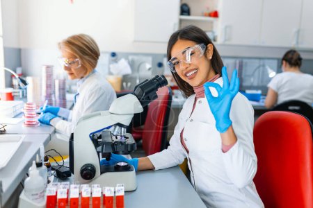 Photo for Medical Science Laboratory: Portrait of Beautiful Scientist Looking Under Microscope Does Analysis of Test Sample. Ambitious Young Biotechnology Specialist, working with Advanced Equipment - Royalty Free Image