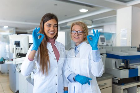 Photo for Scientist showing OK sign in research laboratory. Advanced Scientific Lab for Medicine, Biotechnology, Microbiology Development - Royalty Free Image