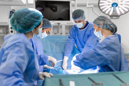Photo for Team of surgeons is fighting for life, for a real operation, for real emotions. The intensive care team is fighting for the life of the patient. Saving life, the struggle for life - Royalty Free Image