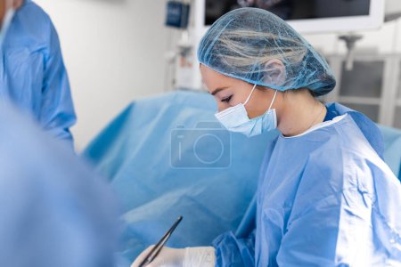 Photo for Doctor and assistant nurse operating for help patient from dangerous emergency case .Surgical instruments on the sterile table in the emergency operation room in the hospital.Health care and Medical - Royalty Free Image