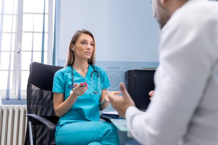 Photo for Serious man consulting with young female physician doctor at checkup meeting in hospital. Skilled general practitioner giving healthcare medical advices to patient. - Royalty Free Image