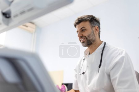 Photo for At the medical clinic, Caucasian male doctor doing the doppler ultrasound test evaluation of arteries and veins on a female patient - Royalty Free Image