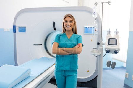Photo for Beautiful happy female doctor physician radiologist standing in CT CAT Scan room at hospital. - Royalty Free Image